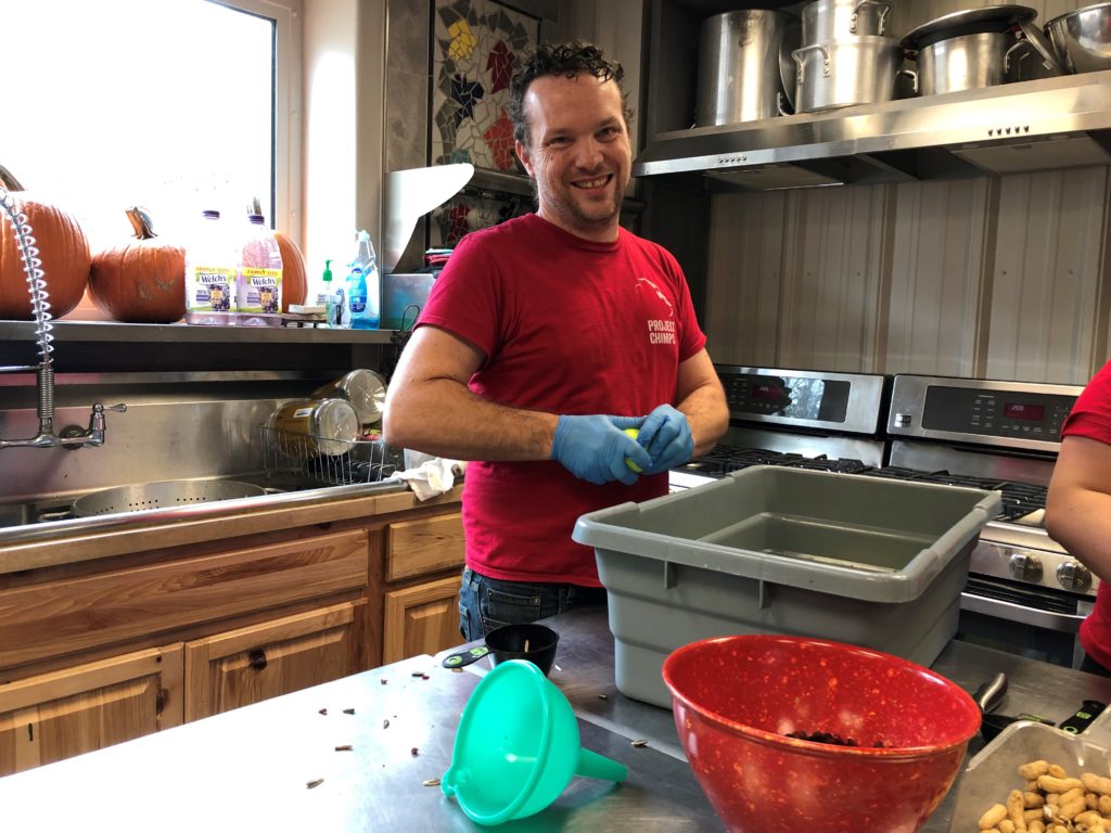 Volunteer Shannon Michael prepares foods for the chimpanzees at Project Chimps.